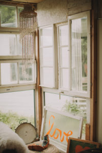 Alternative interior furnishing in a garden shed, window with the inscription 'Love' Alternative interior furnishing in a garden shed, window with the inscription 'Love'